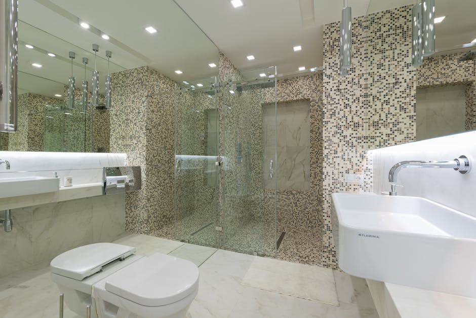 Modern luxury bathroom renovation featuring a sleek walk-in shower and elegant vanity